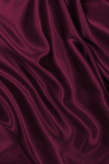 Smooth elegant pink silk or satin luxury cloth texture as abstract background. Luxurious background design