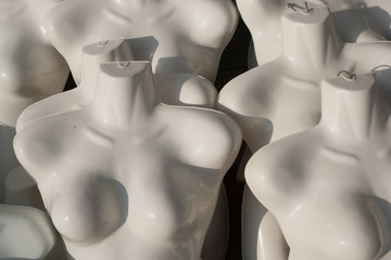 Female mannequin busts in the sun.