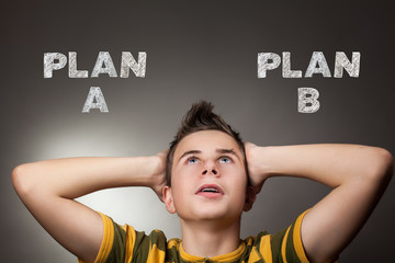 Young boy looking up at plan a and plan b