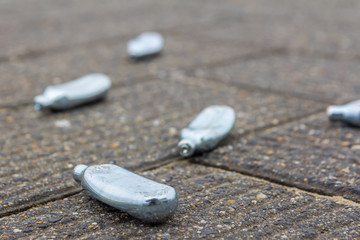 empty nitrous oxide bulbs lying scattered on the street, also known as laughing gas or hippie crack...
