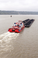 Tugboat Pushing a Heavy Barge
