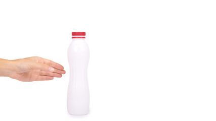 bottle of yoghurt with a red cap in hand isolated on white background, healthy lifestyle, plastic container for milk. copy space, template