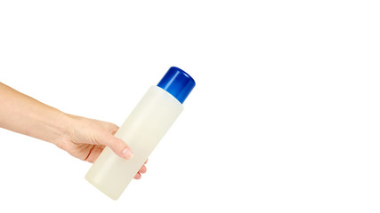 Plastic white shampoo bottle with blue cap in hand isolated on white background. Gel dispenser for hair care. Container with body lotion. copy space, template.