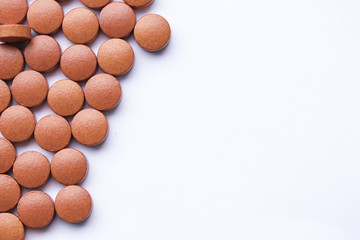 Obraz na płótnie Canvas Red vitamin medication pil background