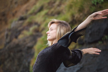 Blonde Woman Stretching Near Cliffs