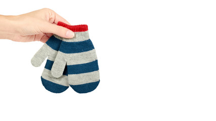 Warm winter children's gloves in hand isolated on white background. Sale and buy. copy space, template