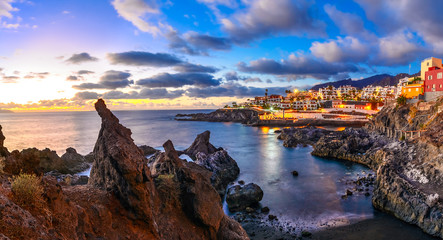 Puerto de Santiago city, Tenerife, Canary island, Spain: Beautiful sunset view of Puerto de Santiago over the rocks and water