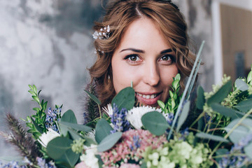 Bride in white wedding dress with a beautiful bouquet.