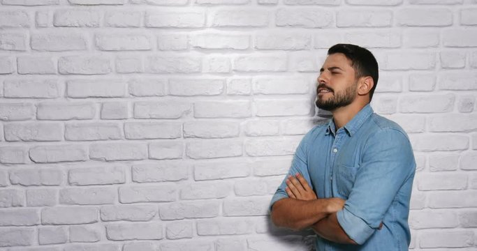 Facial Expressions Of Young Beard Man On Brick Wall