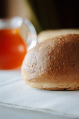 Fresh hot bread on white tablecloth at restaurant table.
