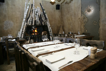 Interior of the northern restaurant with wooden tables and a fireplace