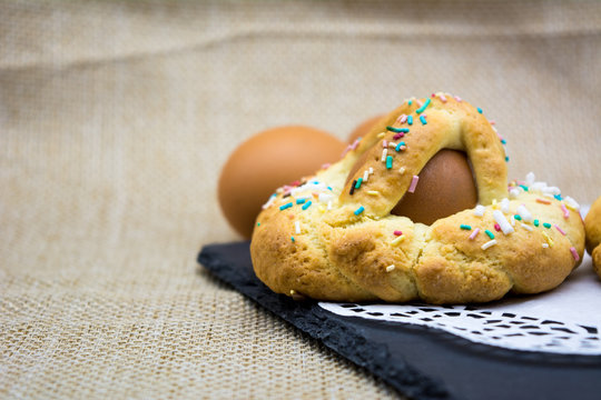 Horizontal View of Italian Baked Food Called Scarcella during Easter Celebrieties on a Black Square Slate Plate on Blur Background