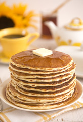 A Stack of Fresh Buttermilk Pancakes with Butter and Syrup