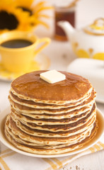 A Stack of Fresh Buttermilk Pancakes with Butter and Syrup