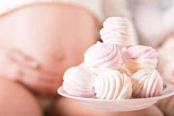 pregnant woman waiting to eat sweets marshmallow