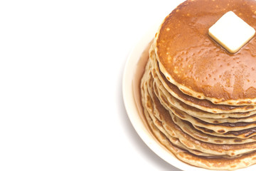 A Stack of Fresh Buttermilk Pancakes with Butter and Syrup on a White Background
