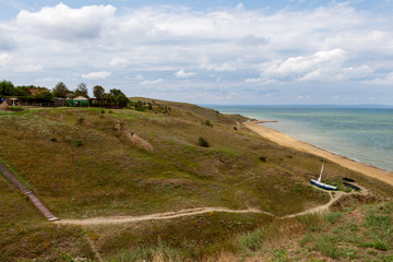 Panorama. rural trail on hilly area against the sea
