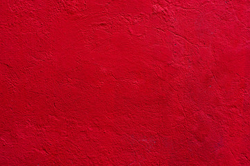 Obraz premium Background of a red stucco coated and painted exterior, rough cast of cement and concrete wall texture, decorative coating