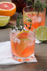 Fototapeta premium Muddled lime and thyme, combined with fresh grapefruit juice and delicious bourbon, it’s the perfect cocktail to serve at any occasion