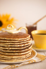 A Stack of Fresh Buttermilk Pancakes with Butter and Syrup