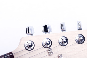 Detail of the headstock of the mast of an electric guitar isolated on white