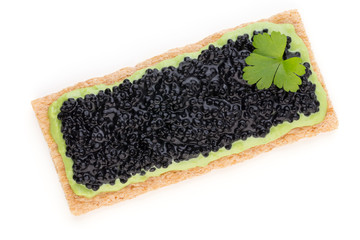 Canapes with black sturgeon caviar and  spice isolated on the white background.