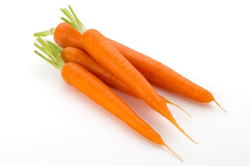 Carrot vegetable with leaves on the wooden background.