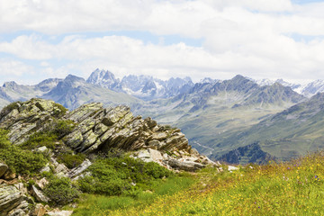 Alpine panorama with slate stone in the foreground, Montafon in Austria.