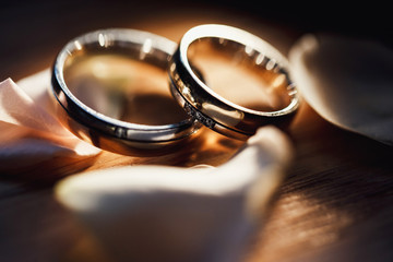 Gold wedding rings on a bouquet of white flowers