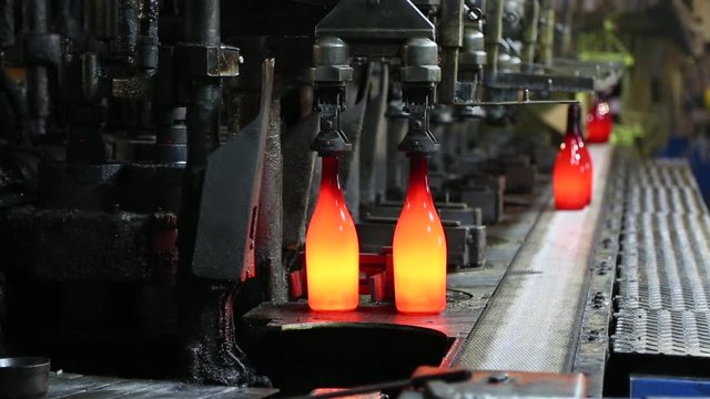 Test run of machine for the production of glass wine bottles. Manufacture of a wine bottle. Manufacture of glass bottles. Factory for the production of bottles, glass plant. Ambient sound at factory.