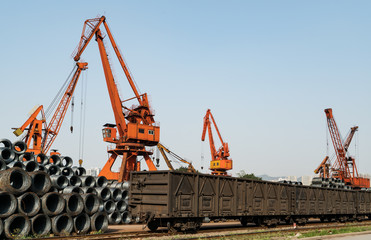 Fototapeta na wymiar Stacking steel and crane, in railway transportation