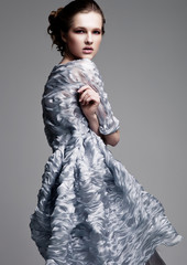 Beautiful fashion model wearing blue silk dress