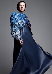 Beautiful fashion model wearing blue silk dress