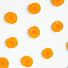 Bright round ringlets of carrots on a white background. Healthy food concept. Top view, flat lay