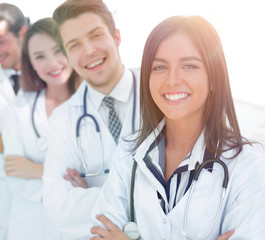 Fototapeta premium female doctor with group of happy successful colleagues
