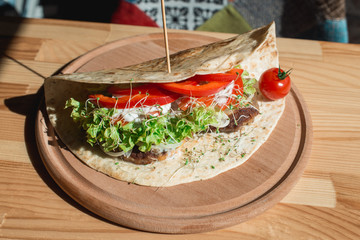 great mexican taco with meat schnitzel with cheese and vegetables