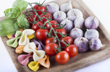 Tomatoes, garlic, basil and colourful pasta