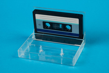 Blank cassette tape box on blue background. Vintage cassette tape case with retro cassette mockup....