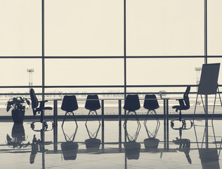Fototapeta na wymiar Negotiation area with desk, seats and marker board near panoramic window