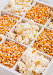 Raw golden sweet corn seeds and popcorn in box