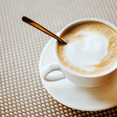 Freshly brewed cup of cappuccino with milk foam