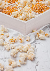 Raw golden sweet corn seeds and popcorn in box