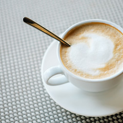Freshly brewed cup of cappuccino with milk foam