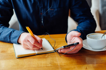 Young man taking business notes and checking his schedule