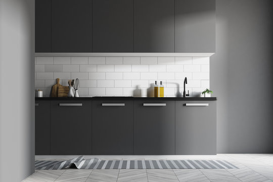 White kitchen interior, dark gray counters