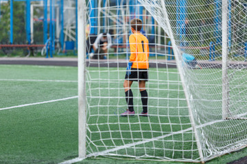 young boys play football, show dribbling, make passes to win on the summer spring  field