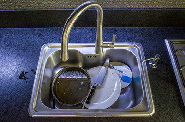 Unwashed dishes in sink close