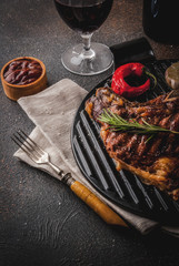 Fresh grilled meat beef steak with with red wine, herbs and spices. copy space dark rusty background