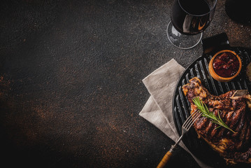 Fresh grilled meat beef steak with with red wine, herbs and spices. copy space dark rusty background