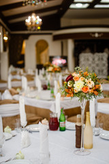 wedding decor on tables  in restaraunt, a bouquet of flowers with a glass vase